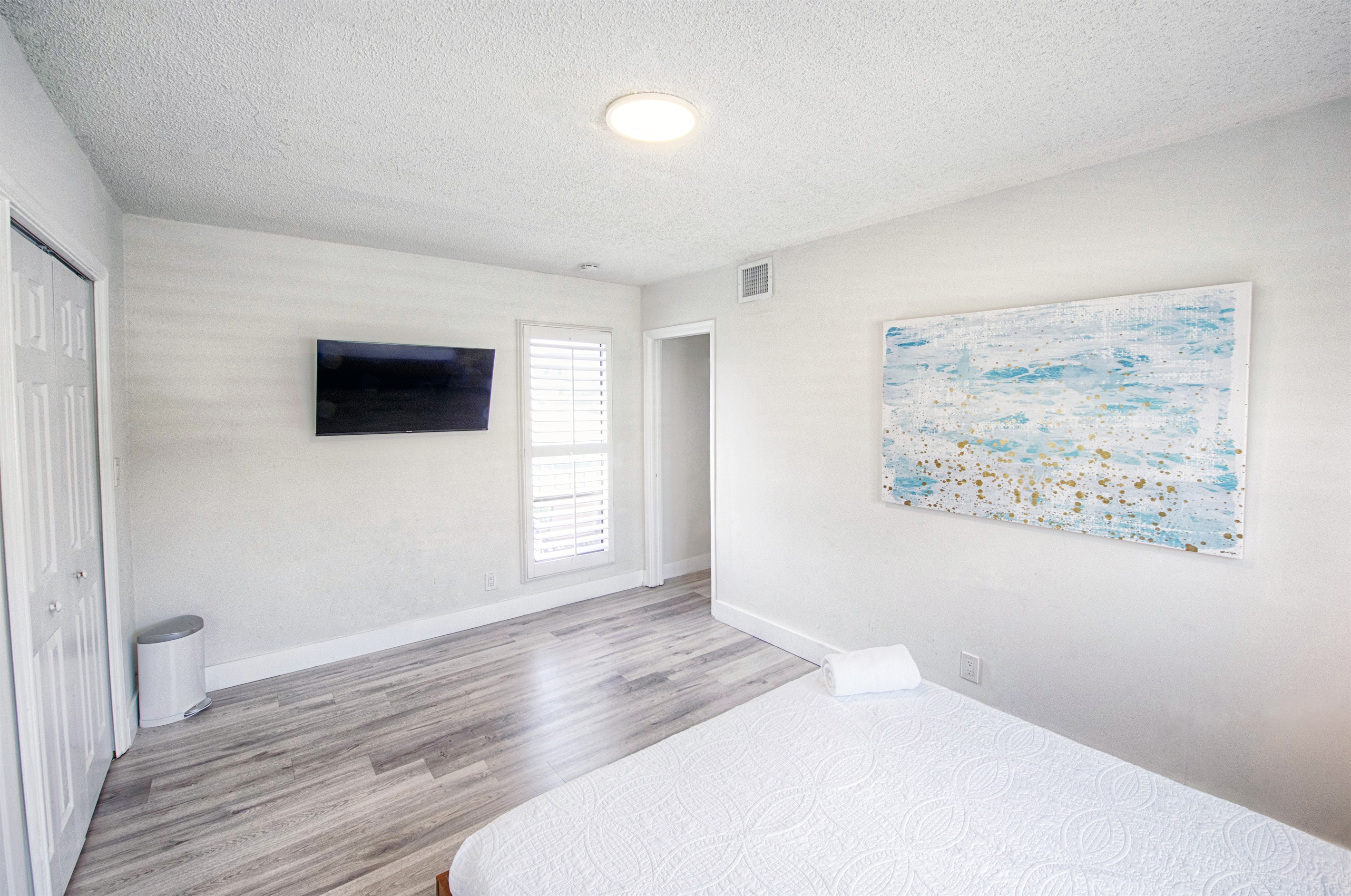 Featuring smart TV with large window in your primary bedroom.