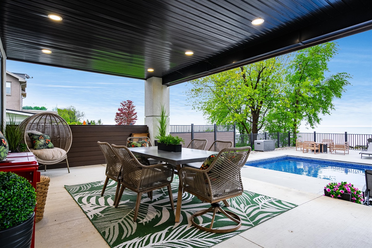 Covered veranda with outdoor kitchen and dining.