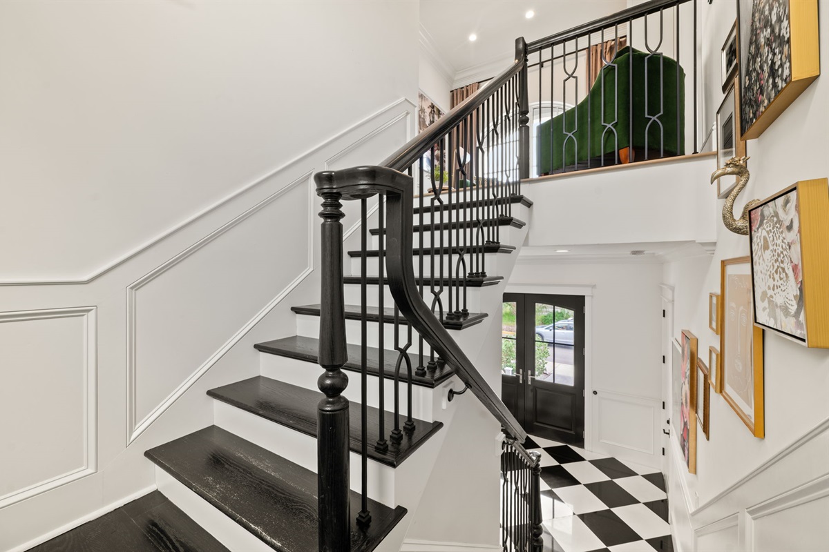 The grand stairs lead to 4 private bedroom suites