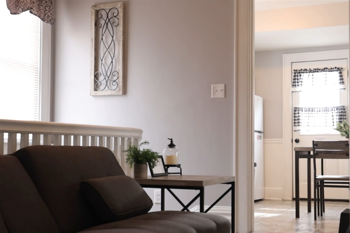 The futon is just up the stairs, outside of the kitchen.