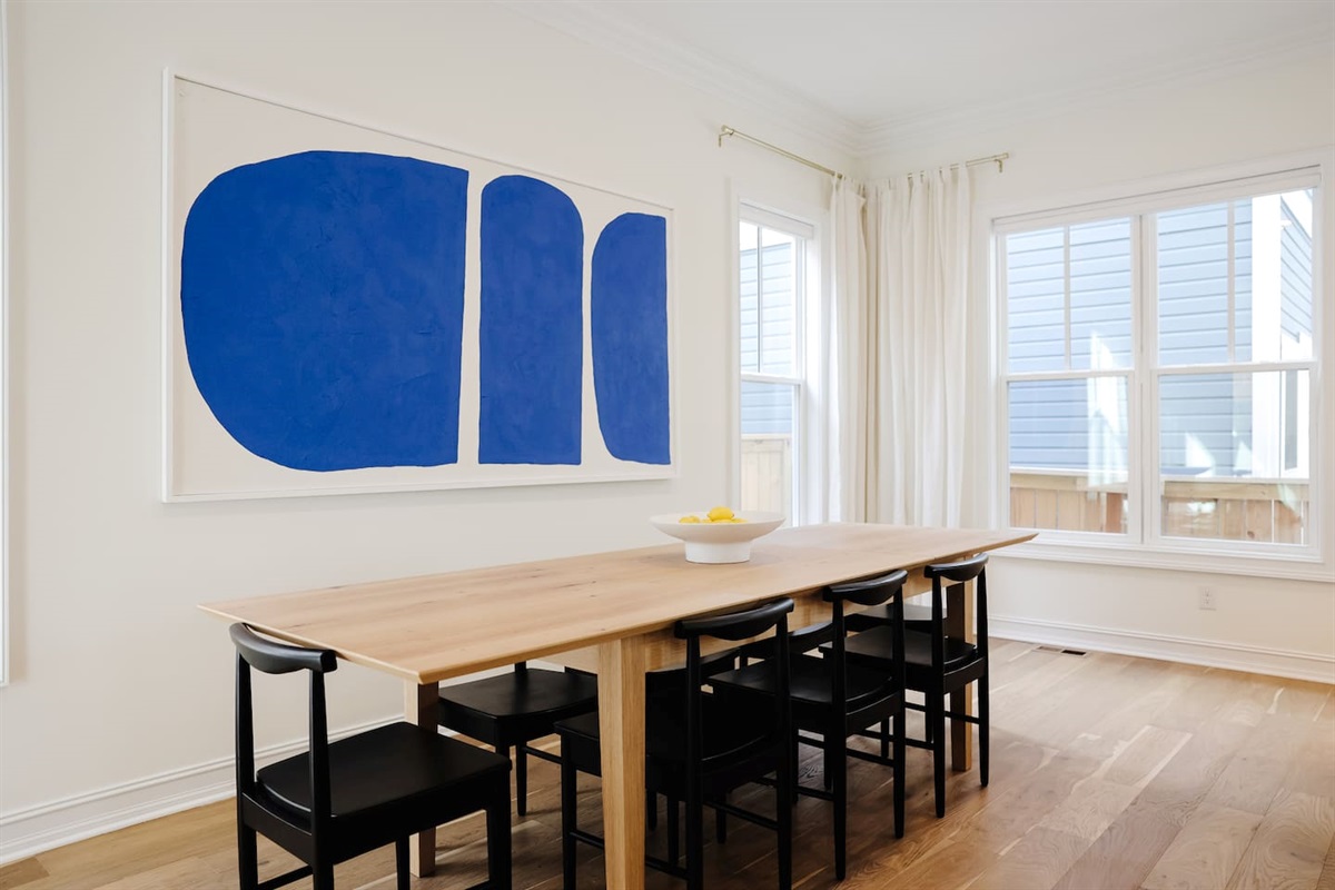 The oversized 8-seat dining table is great for large groups. Featuring custom commissioned art from locals, Modern Coast Co.