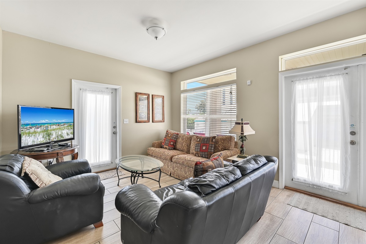 Living Room #1 (First Floor) – Sleeper sofa, loveseat, accent chairs & large TV