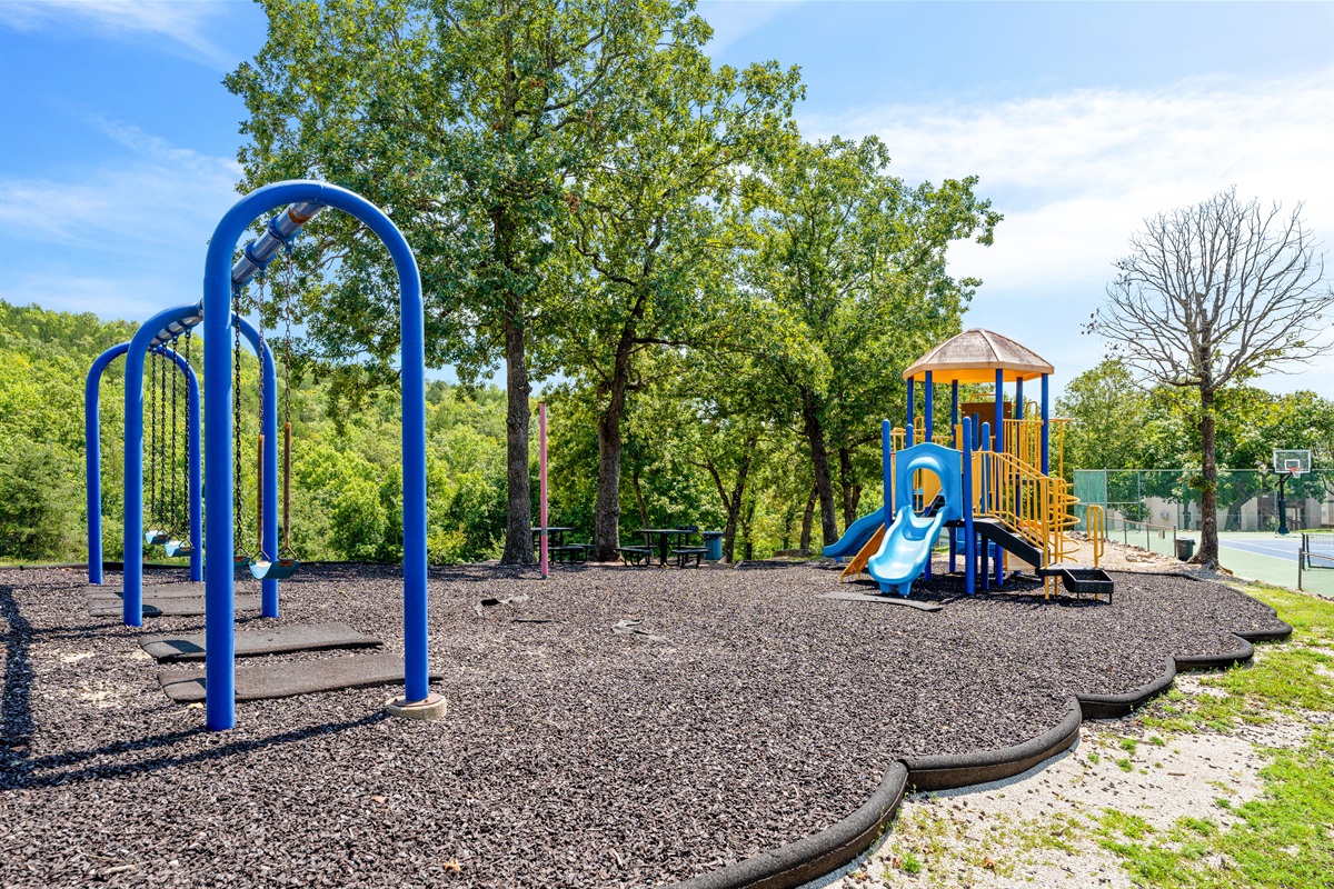 A shaded playground gives little ones space to climb, swing, and play while the grown-ups relax nearby.