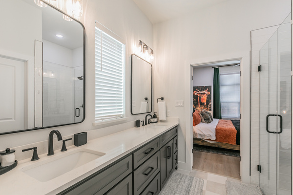 Main bathroom with double vanity and walk-in shower