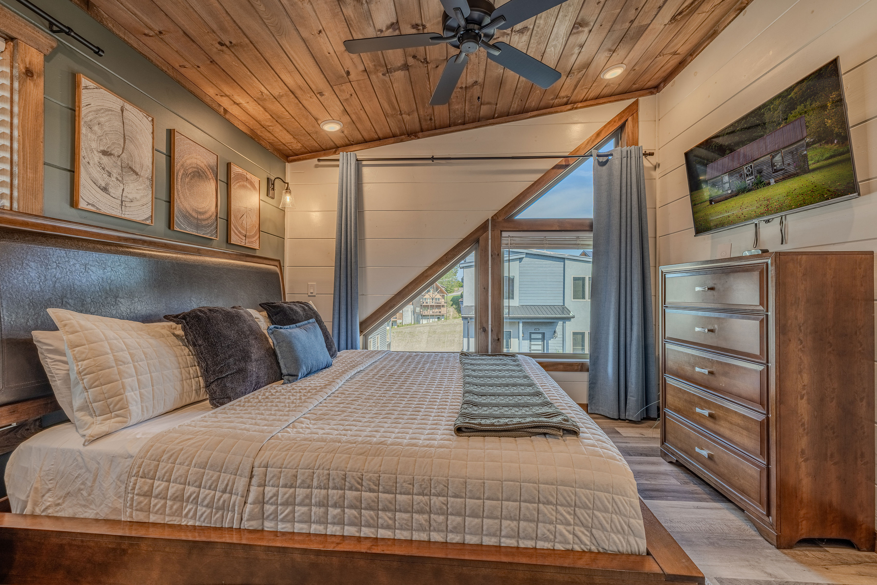 Upstairs King bedroom with an airy layout and vaulted wood ceiling.