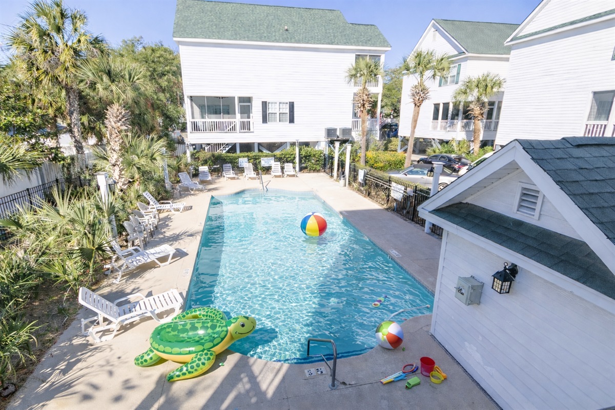 Welcome to Hola Beaches! Unwind in the serene poolside oasis, surrounded by swaying palms and comfy loungers