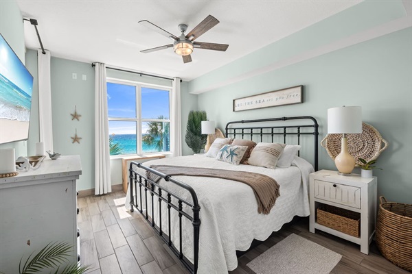 Rest in comfort in the Primary King Bedroom with a 4" memory foam mattress topper overlooking the ocean 