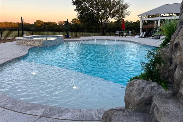 Resort style 30,000-gallon saltwater pool with double waterfalls and grotto and slide