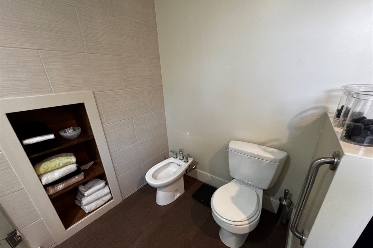 The primary ensuite is designed for ultimate comfort, featuring modern fixtures and a private bidet. With built-in linen storage and plenty of space, this master bathroom offers a true spa experience just steps from the Acadia border.