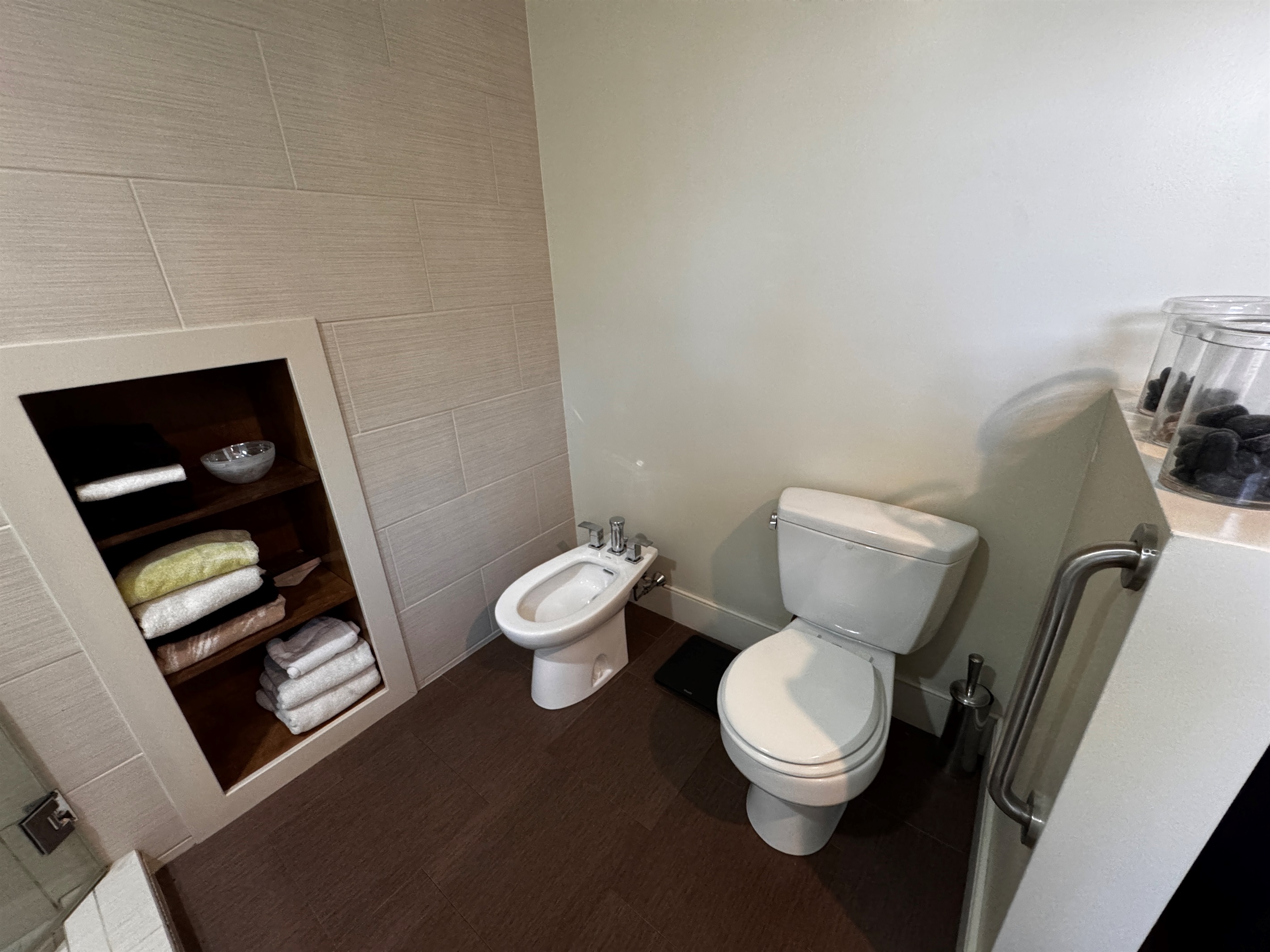 The primary ensuite is designed for ultimate comfort, featuring modern fixtures and a private bidet. With built-in linen storage and plenty of space, this master bathroom offers a true spa experience just steps from the Acadia border.