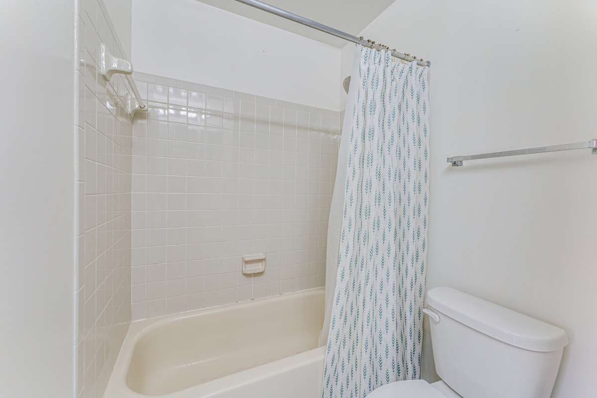 Conveniently located for guests, the second full bathroom features a bathtub, fresh towels, and everything needed to get ready for the day.
