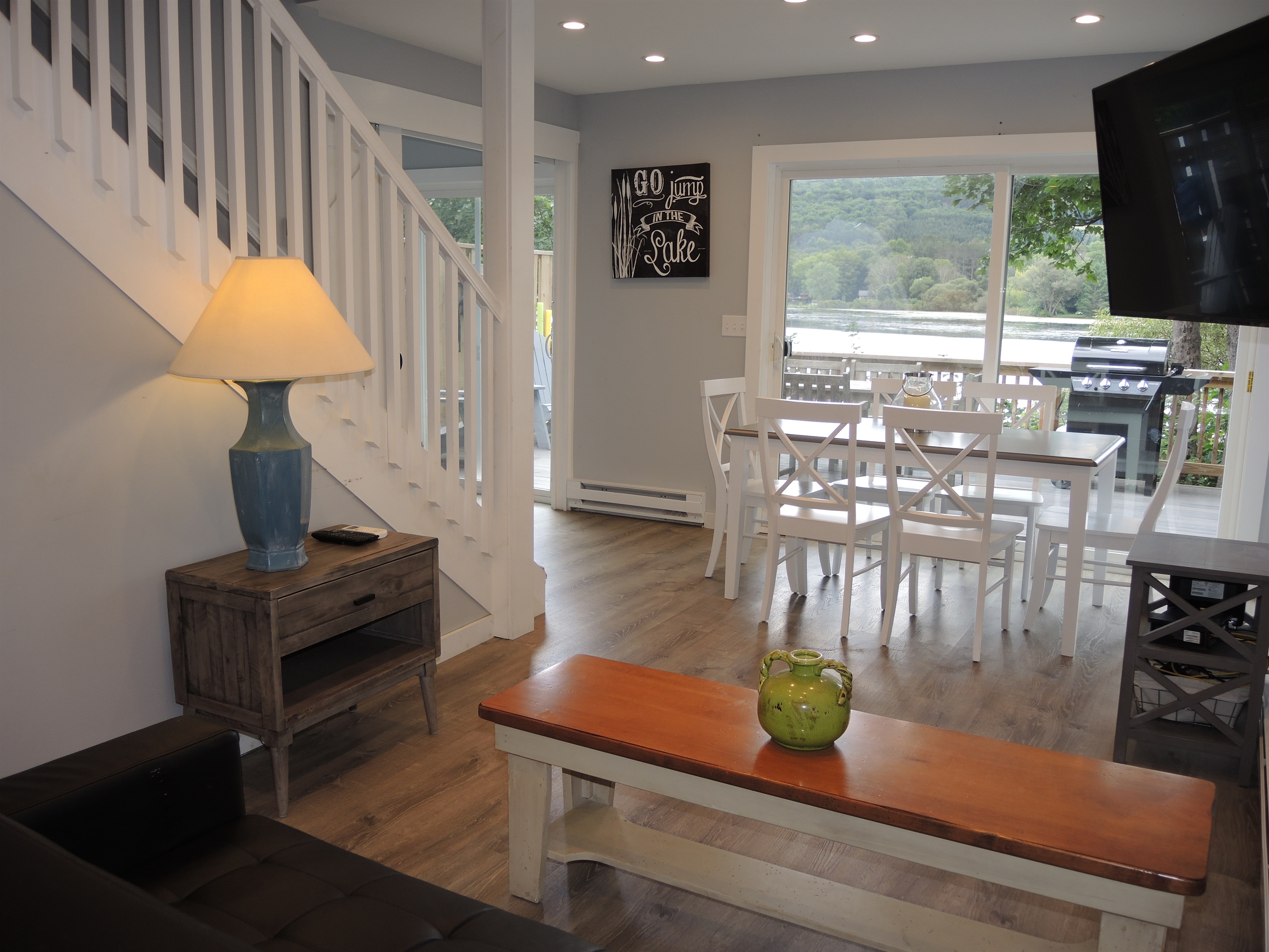 Open floor plan flow from living to dining to deck