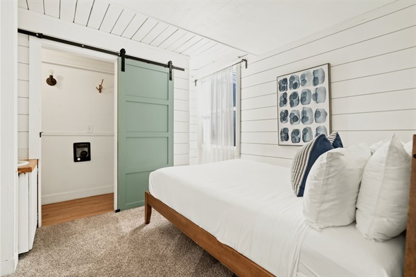 Main floor level bedroom with private bathroom and Queen bed