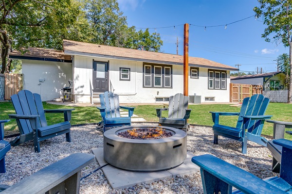 Backyard firepit with Adirondack chairs and a warm, welcoming atmosphere