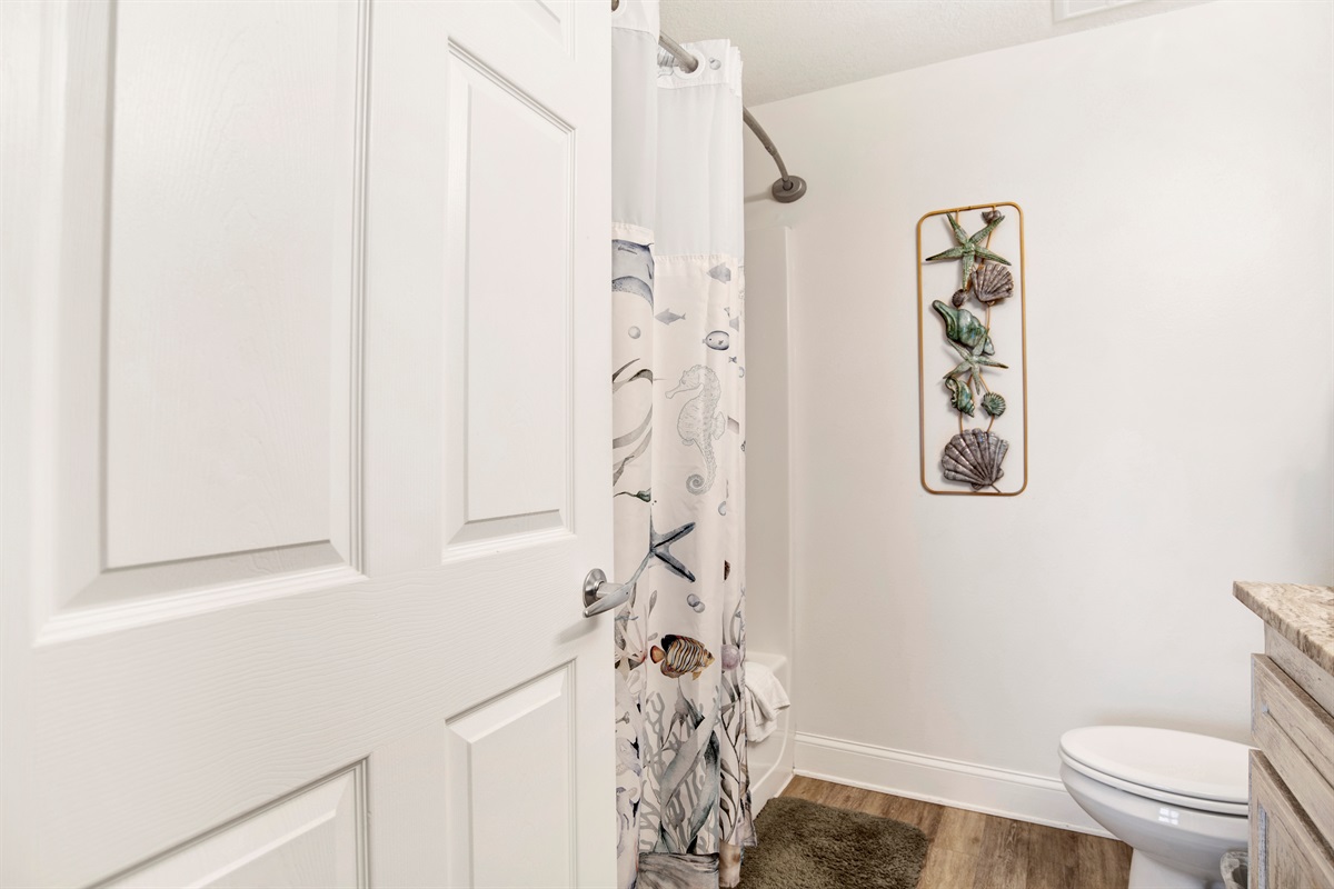 Master bathroom with tub/shower combo and extra long vanity with granite top.