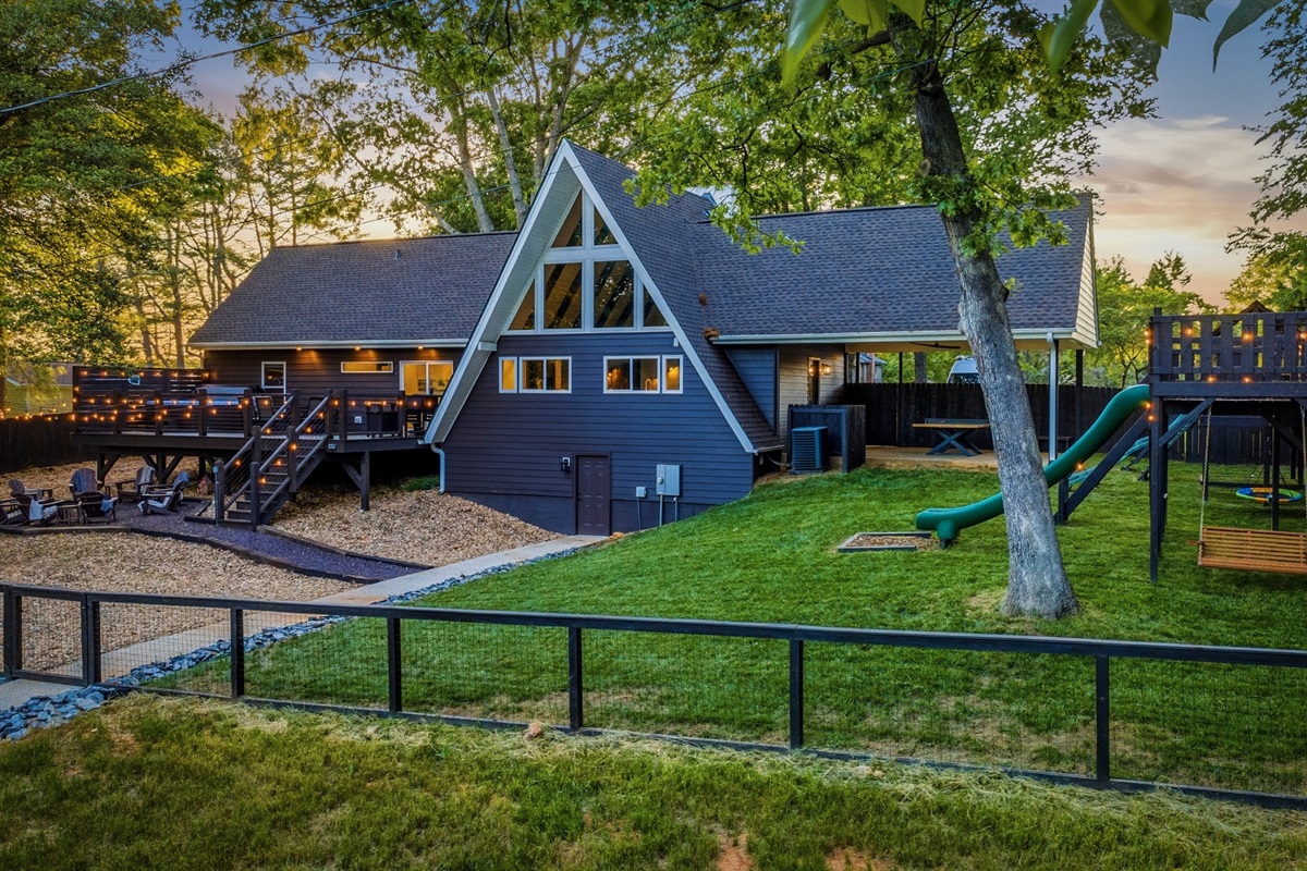 Fenced backyard, fort, A-frame — the trip, in one frame.