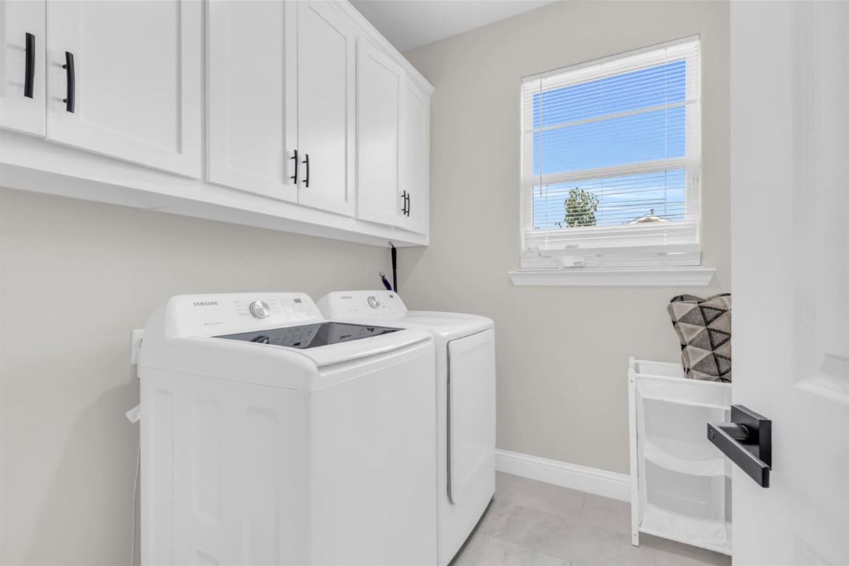 Convenient laundry room with modern washer and dryer.