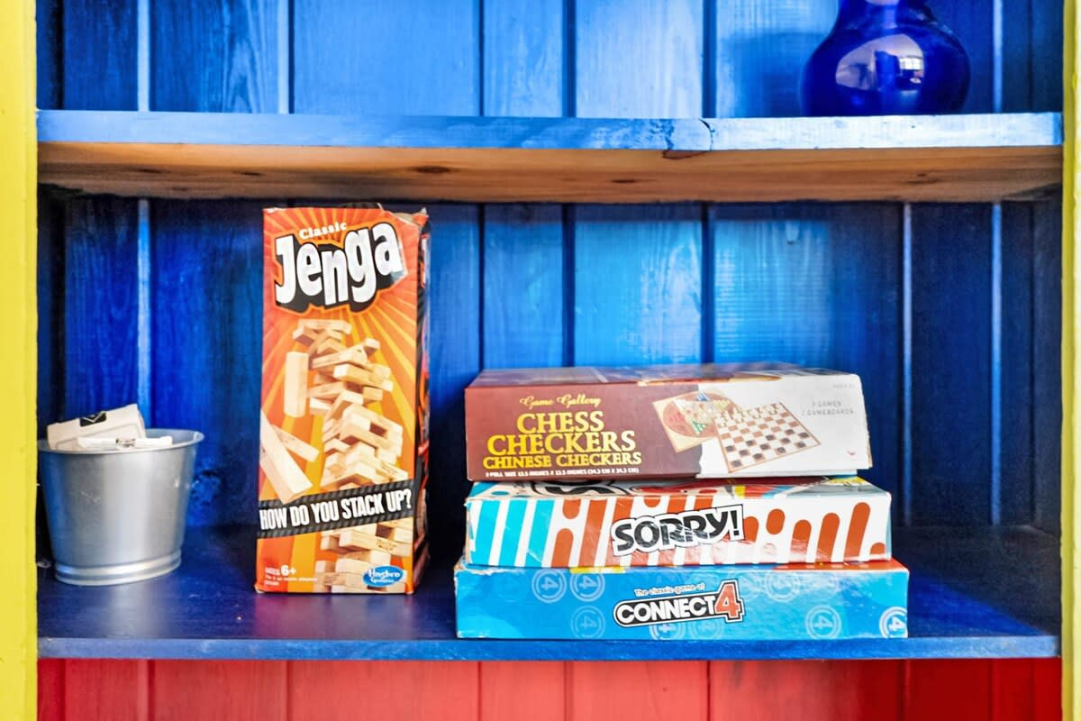 Jenga, Chinese Checkers, Sorry and Connect 4, stacked and ready on the shelf. Every holiday needs one properly competitive evening, and this little cupboard is where that particular tradition tends to begin.
