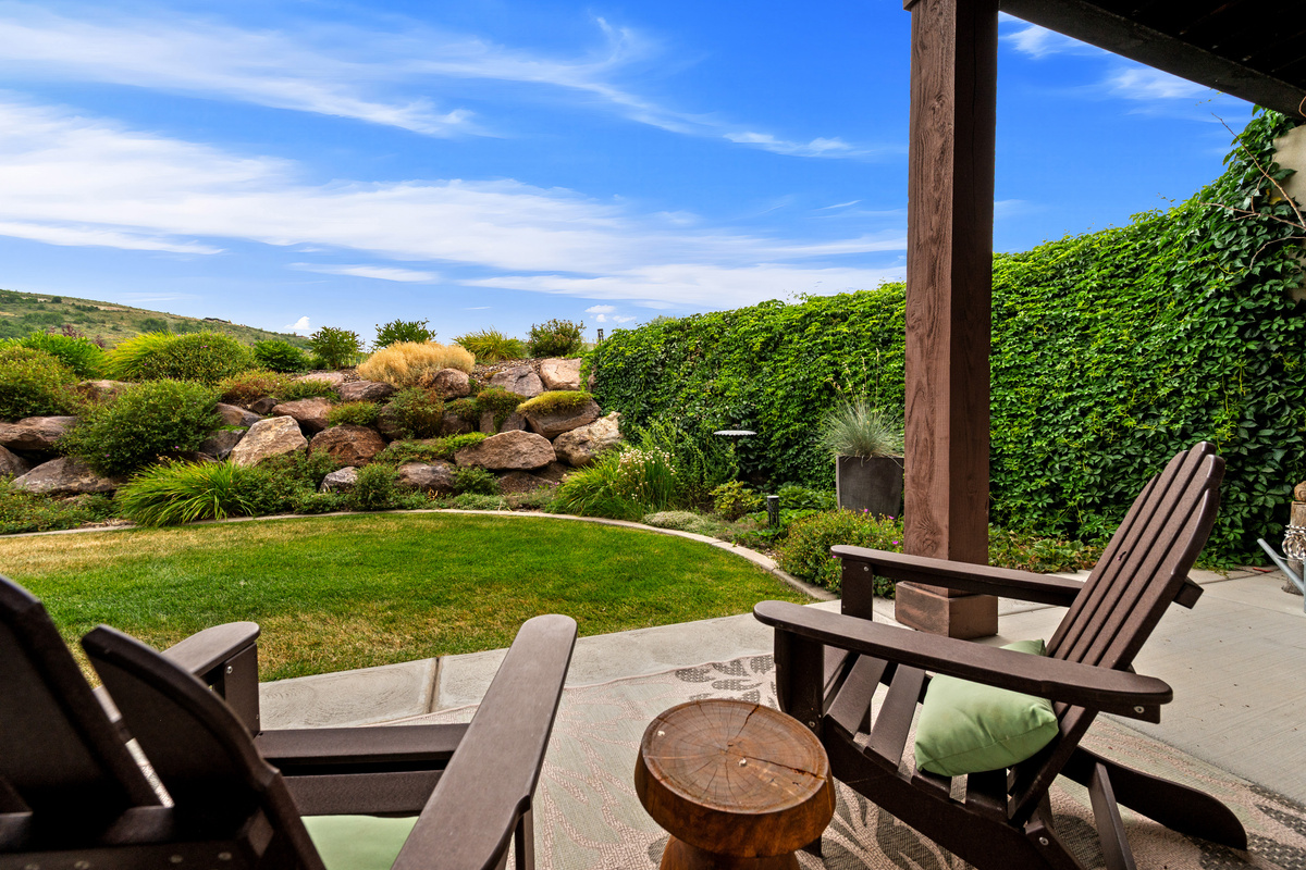 Relax on the private covered patio overlooking the beautifully landscaped backyard—an inviting spot for morning coffee, evening cocktails, or simply soaking in the peaceful surroundings.
