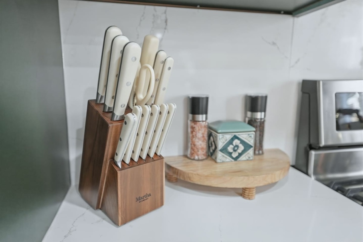 Well-equipped kitchen with a full knife set, salt and pepper grinders, and cooking essentials to help you prepare meals with ease.