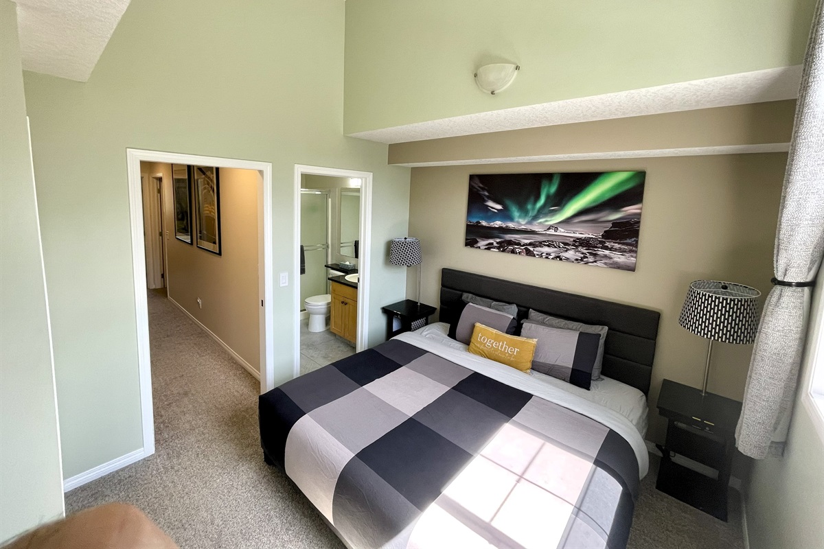 Master Bedroom with ensuite bathroom (visible on the right). Mountain view, and 55" TV.   Located on the 2nd floor.