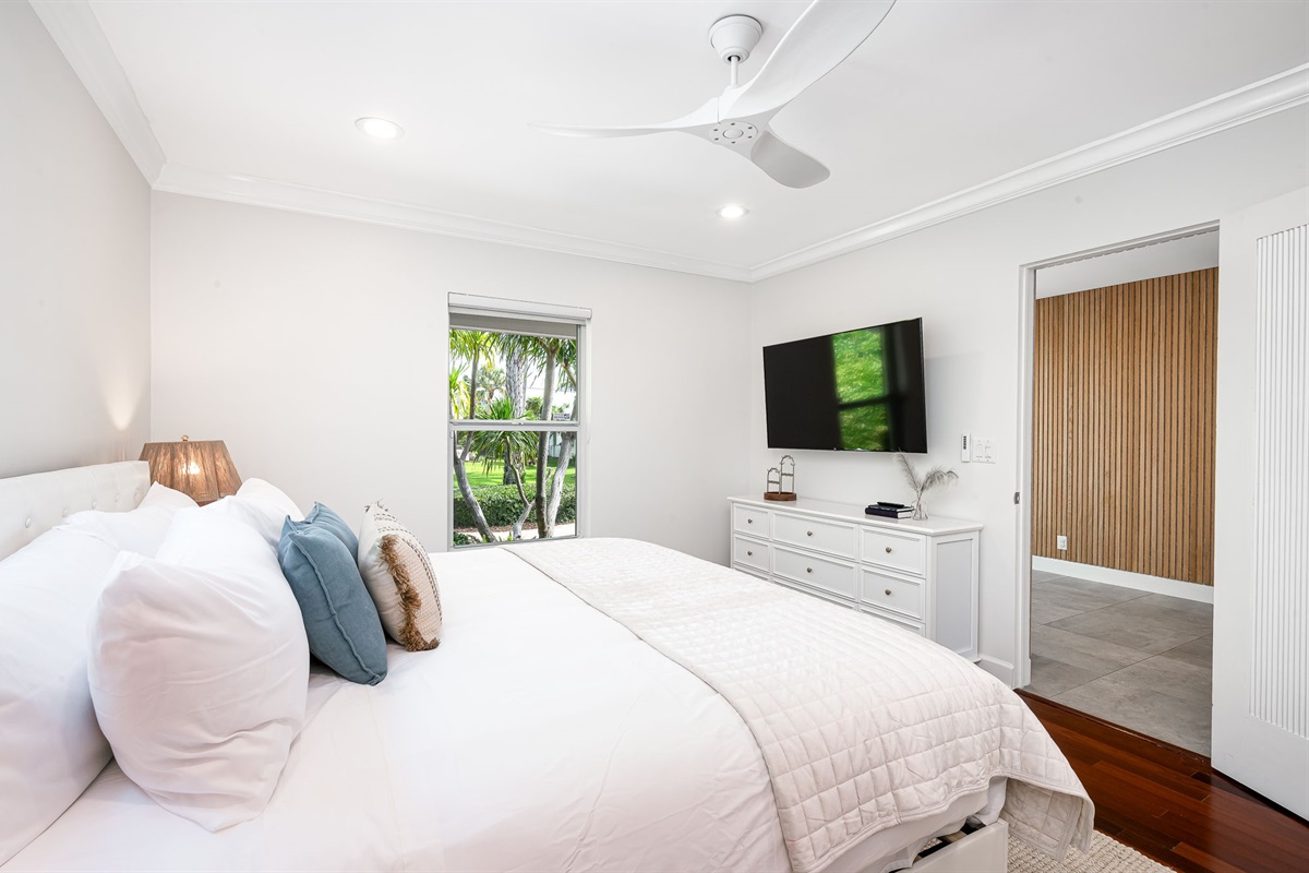Guest Bedroom 1 features a plush King Bed, 55 inch TV and access to the shared bath.