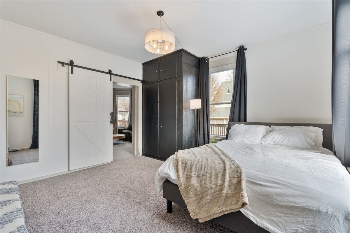 Full closet in the bedroom with Iron, extra bedding and storage.