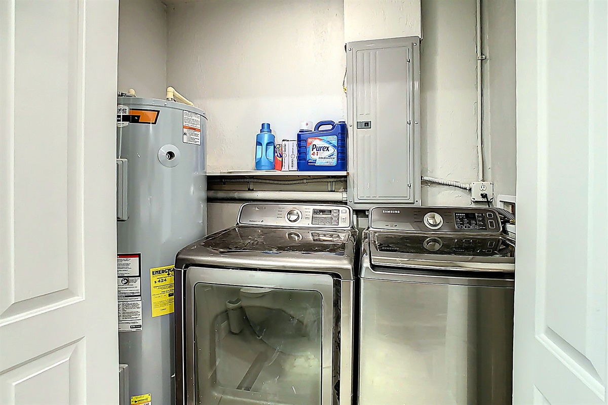 Laundry room with washer and dryer units and detergent storage