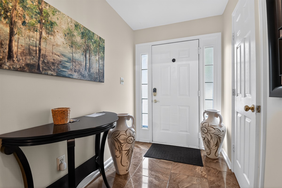 Welcoming Foyer — Front Entry Hall, Natural Light, Direct Access to Three-Story Home