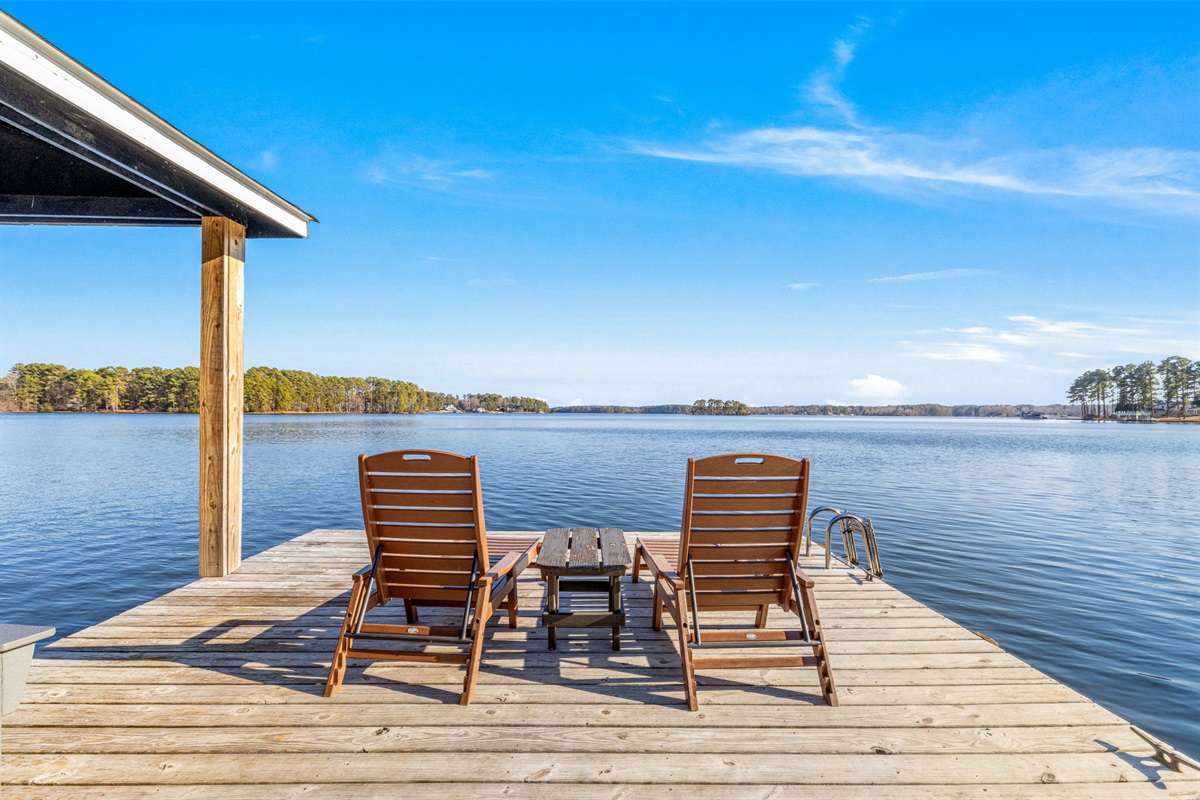 Lakeside Retreat: Unwind in stylish lounge chairs with breathtaking water views!