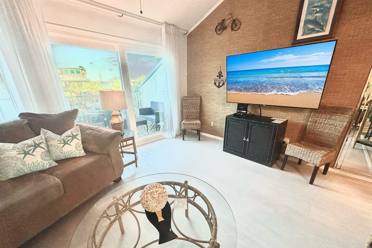 Spacious living room area with large TV!