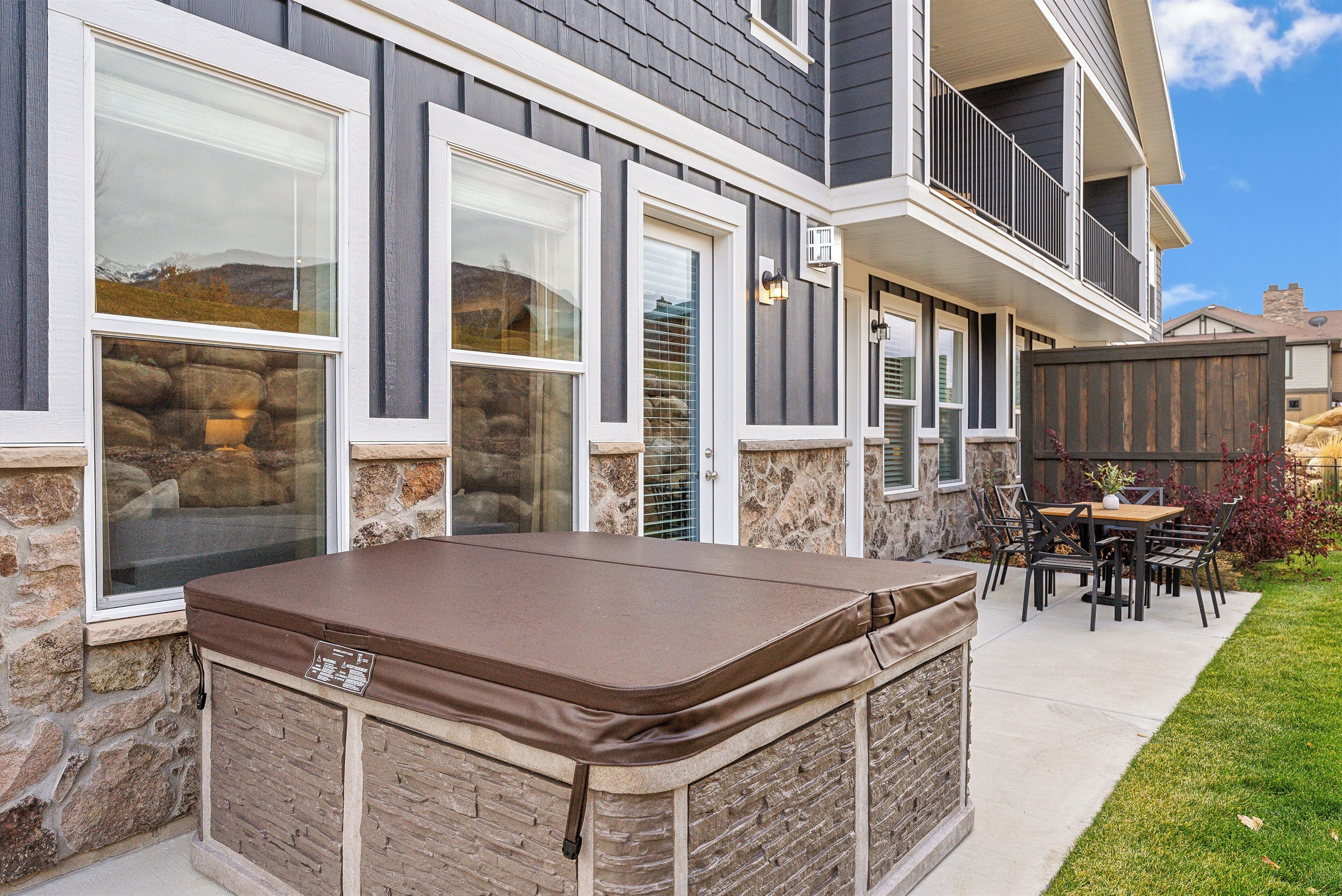 Relax on the patio with outdoor dining and a soothing hot tub—perfect after a day of adventure.