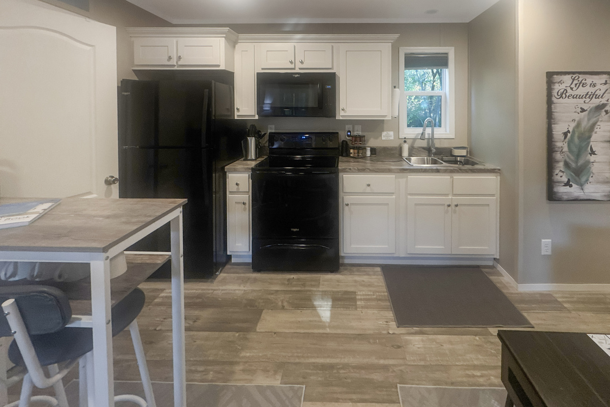 Full kitchen with refrigerator, oven, and microwave