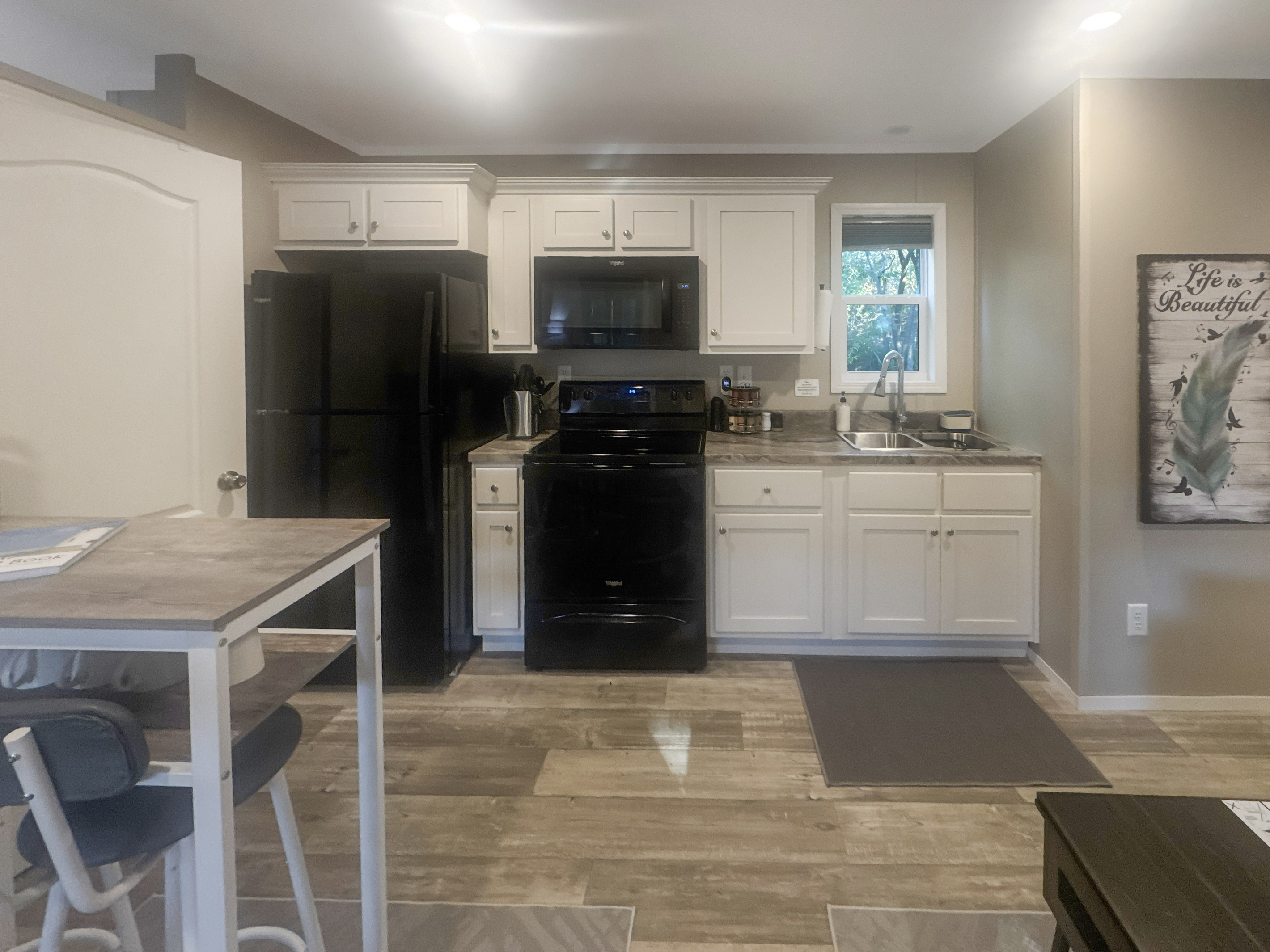 Full kitchen with refrigerator, oven, and microwave