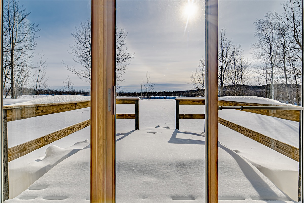 The upstairs living room has large windows and sliding glass door that leads to the deck!