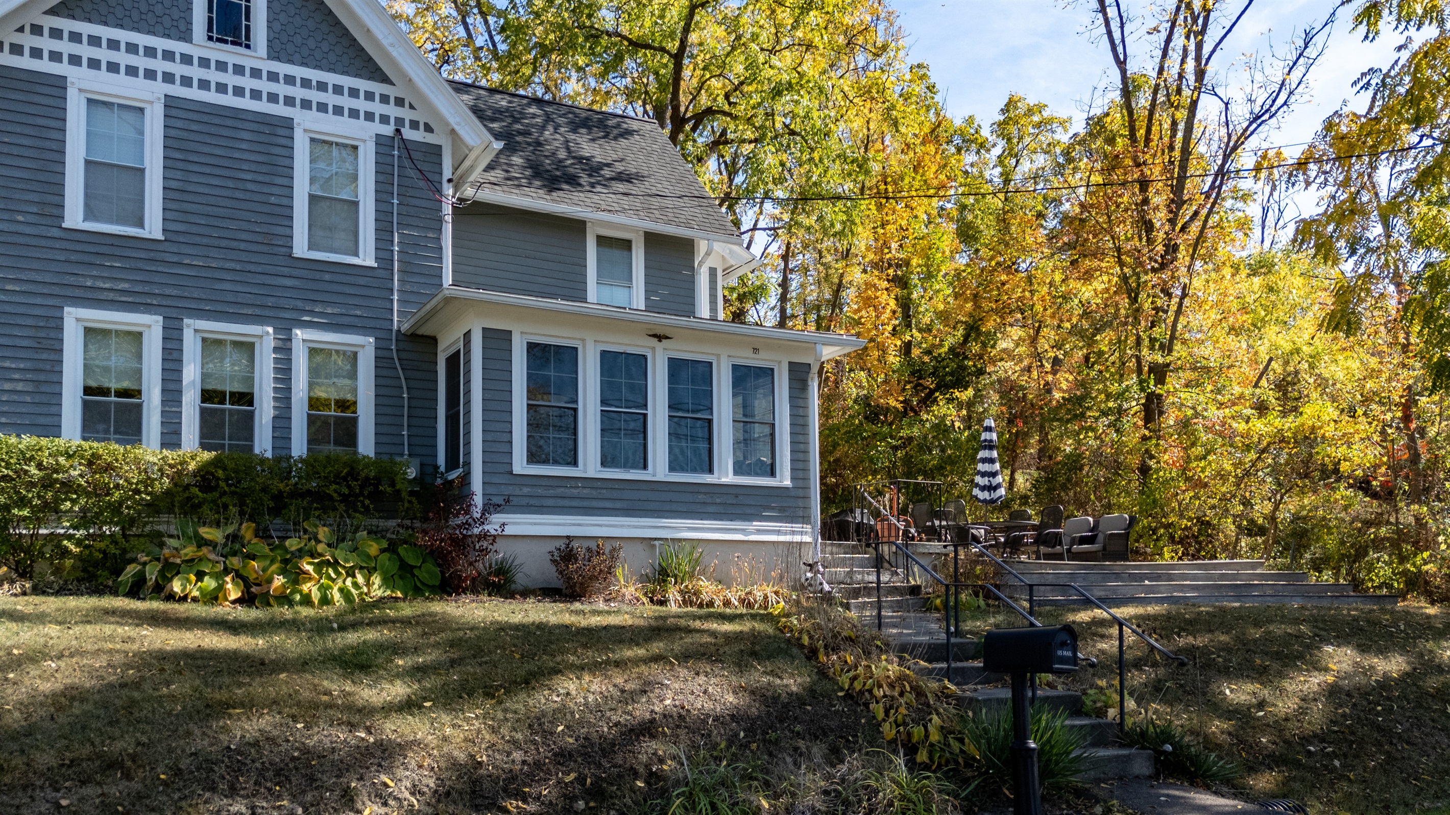 Picture-perfect lake house framed by fall colors — where comfort meets lakeside charm