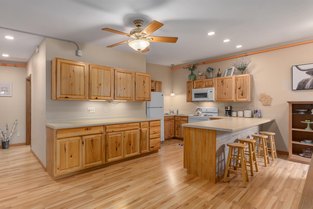 The large kitchen is fully stocked for all your cooking and gathering needs.