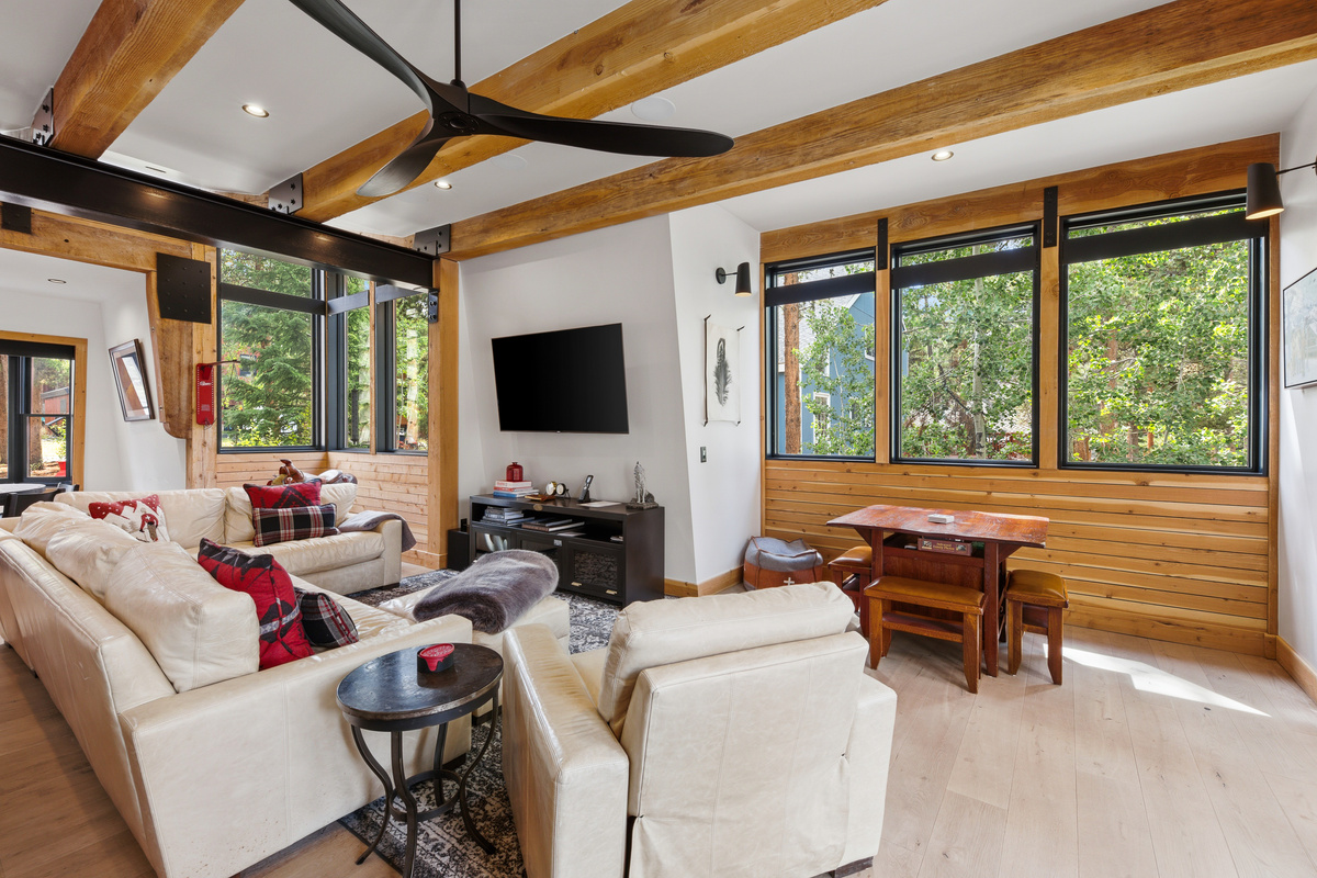 Living area with sectional leather sofa, game table and tv. 