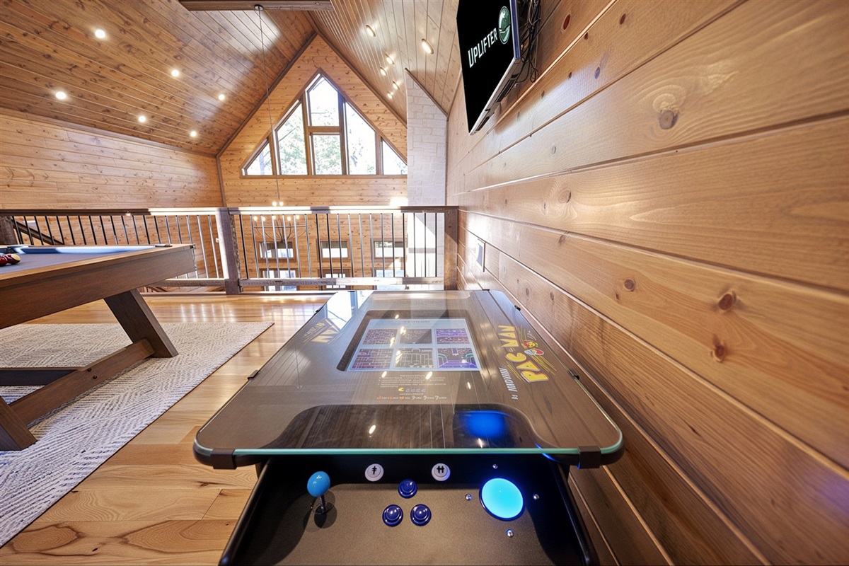 Two-player Ms Pac-Man arcade in the upstairs loft for classic fun and friendly competition.