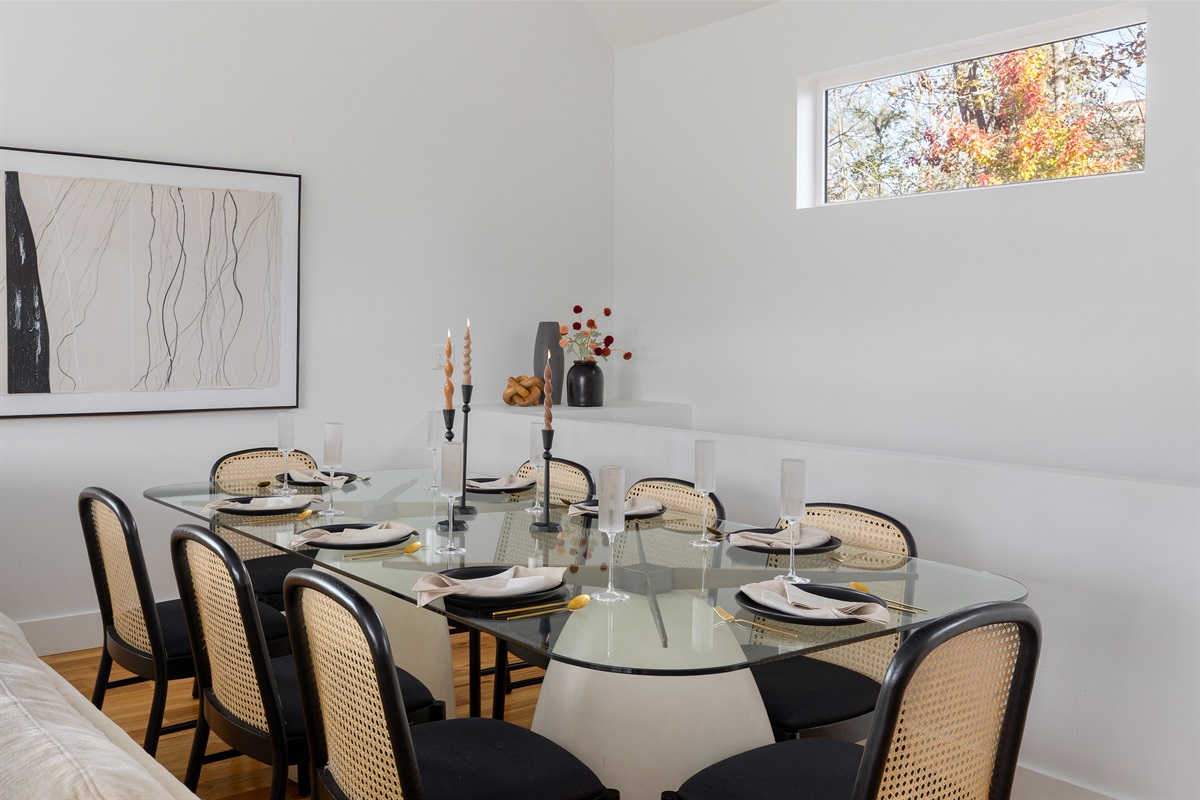 {Dining Room} A beautifully styled glass dining table with seating for your whole group—perfect for shared meals and celebrations.