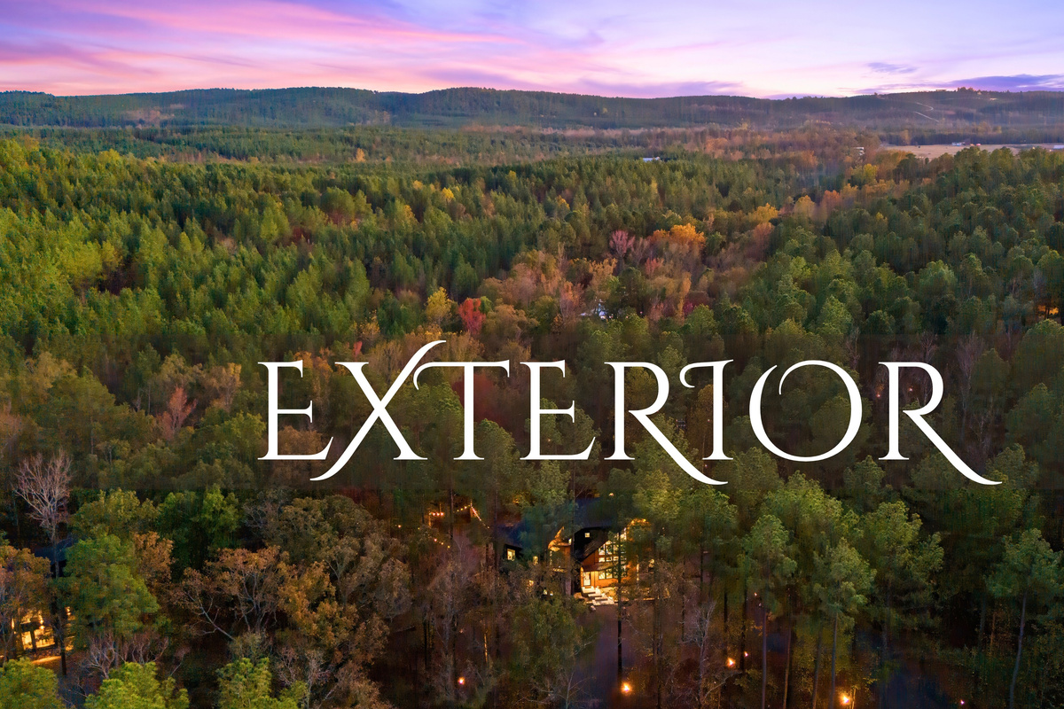 An aerial view that captures the cabin&rsquo;s beautiful setting within the lush forest, inviting you into a world of natural beauty.