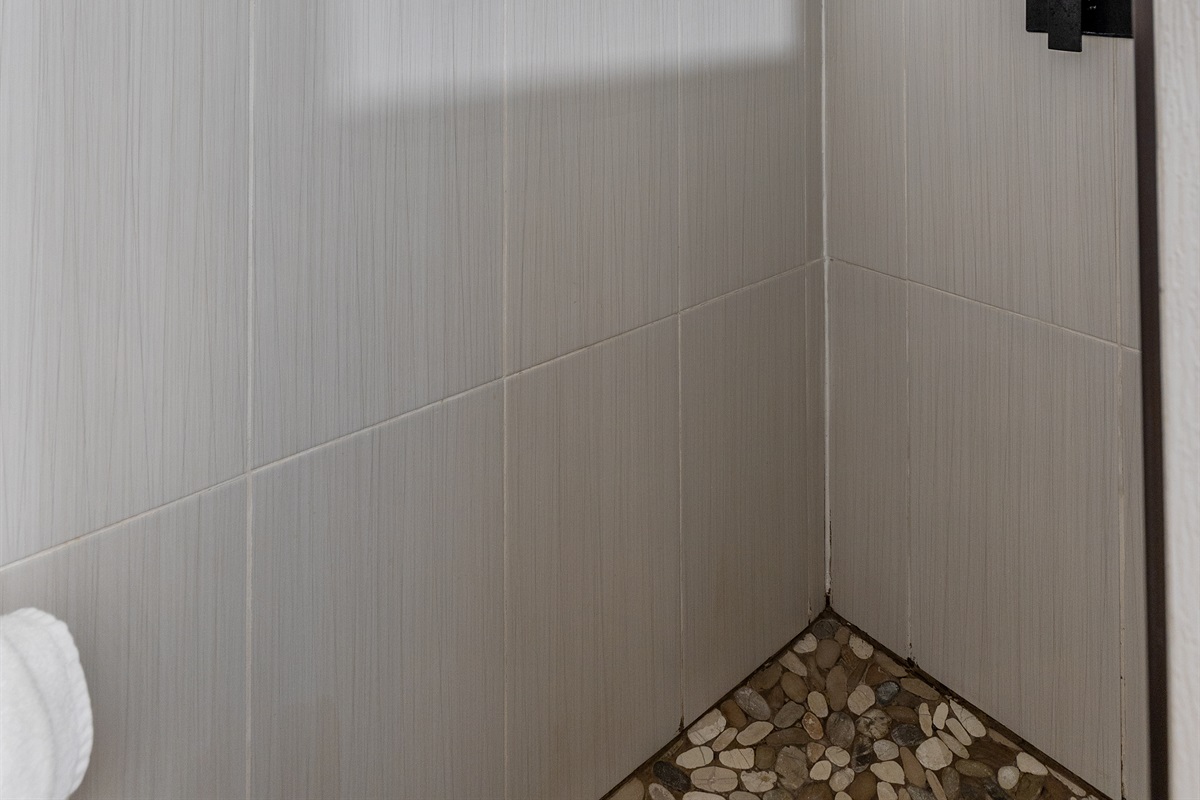 A bright and inviting bathroom with a stand-up shower and all the essentials for your stay.