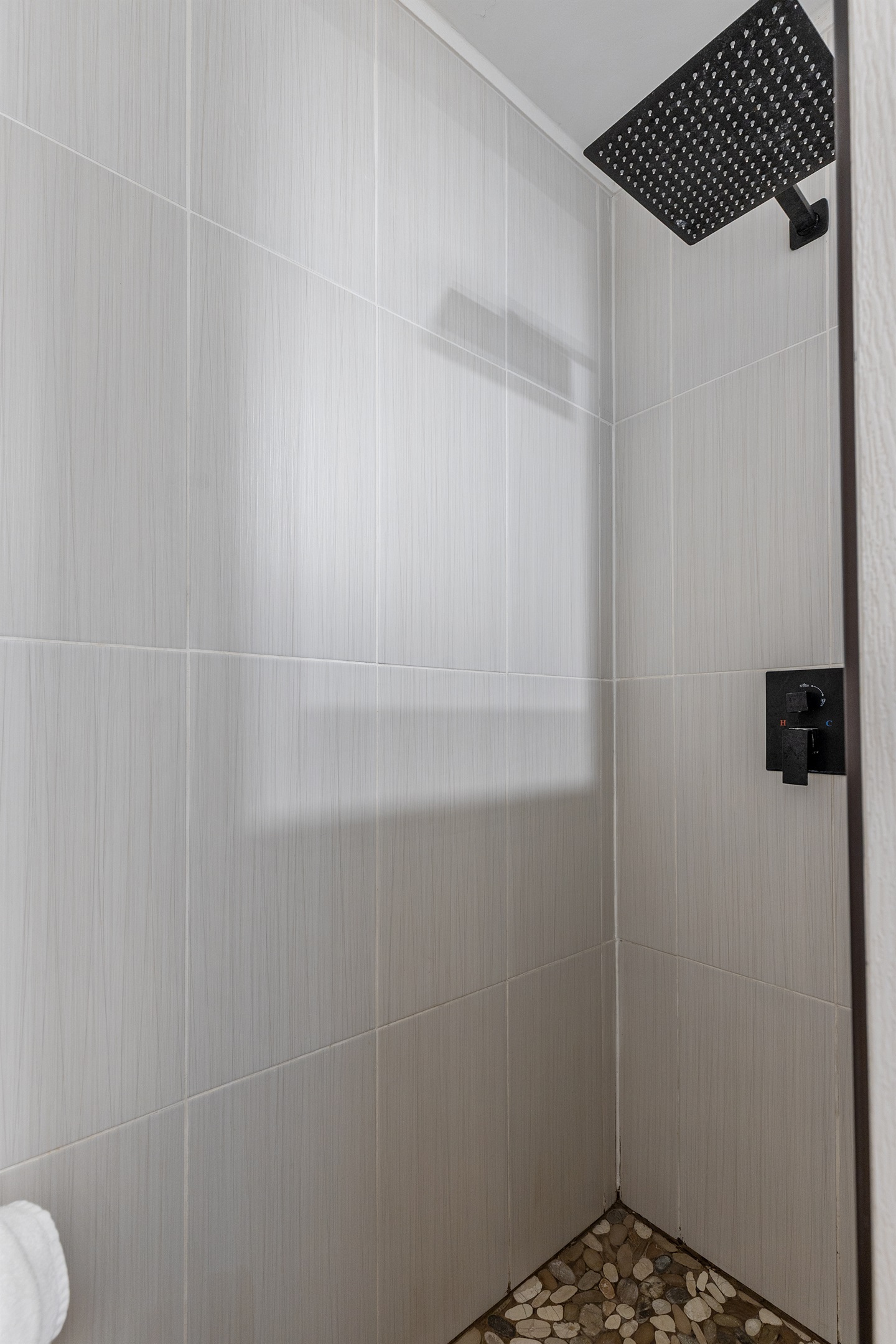 A bright and inviting bathroom with a stand-up shower and all the essentials for your stay.