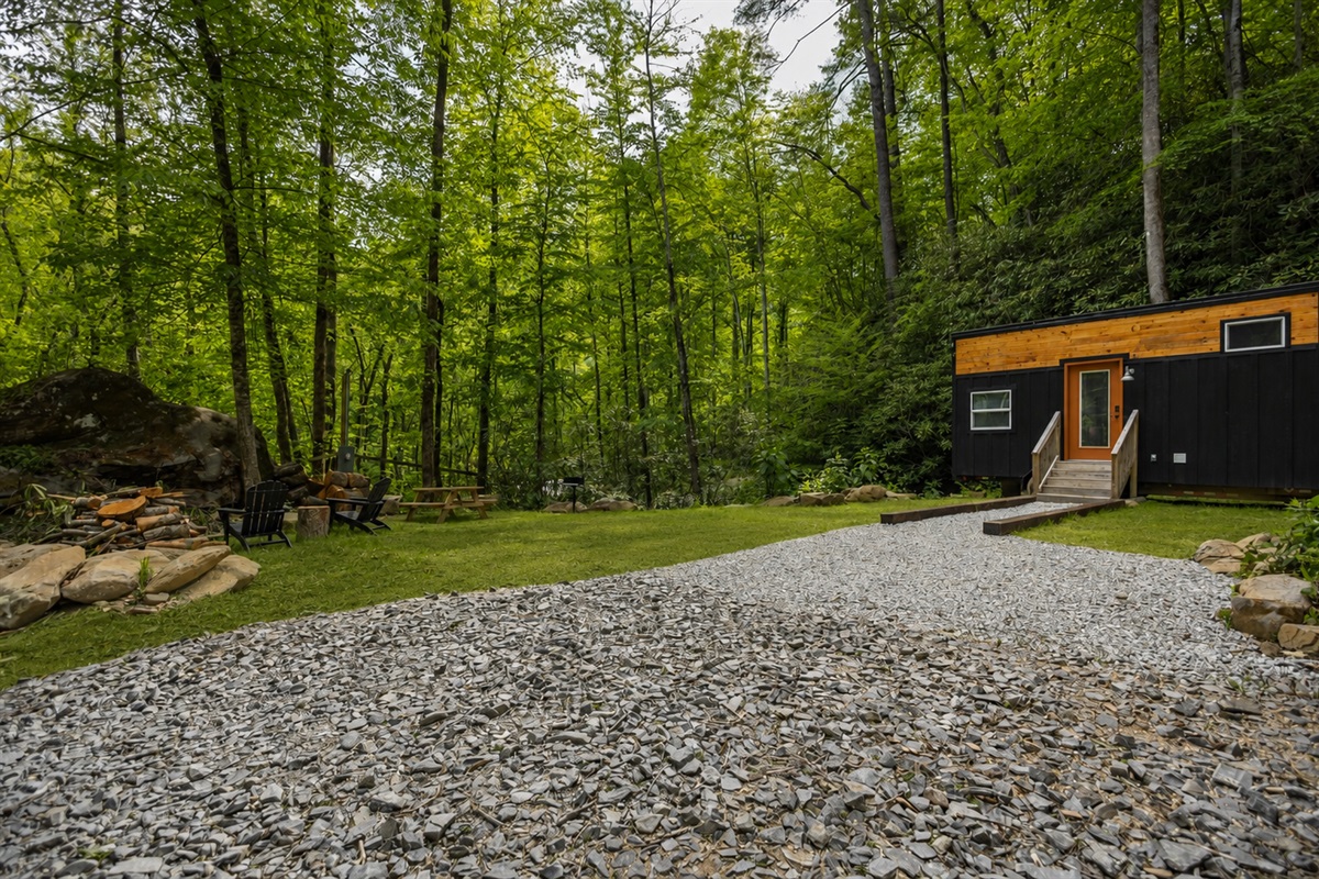 Enjoy the peaceful setting, open yard space, and cozy fire pit just steps from the bungalow.