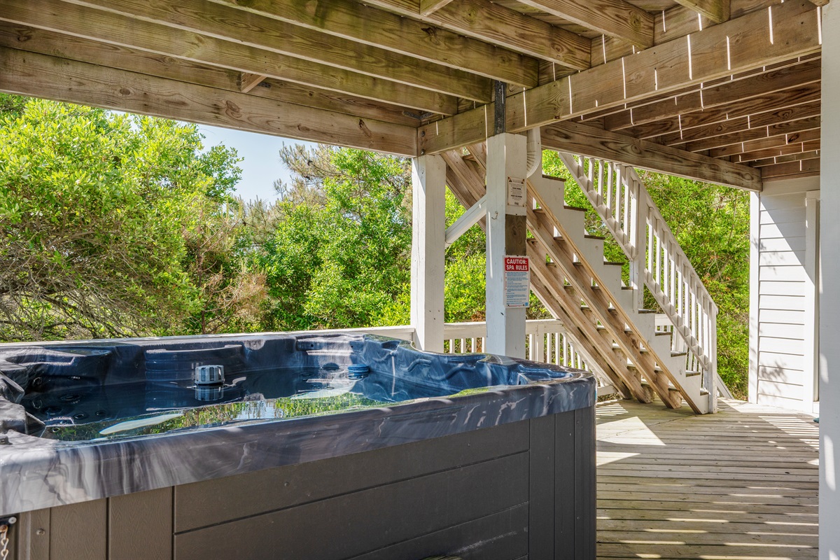 Unwind after beach days with a relaxing soak in the private hot tub.