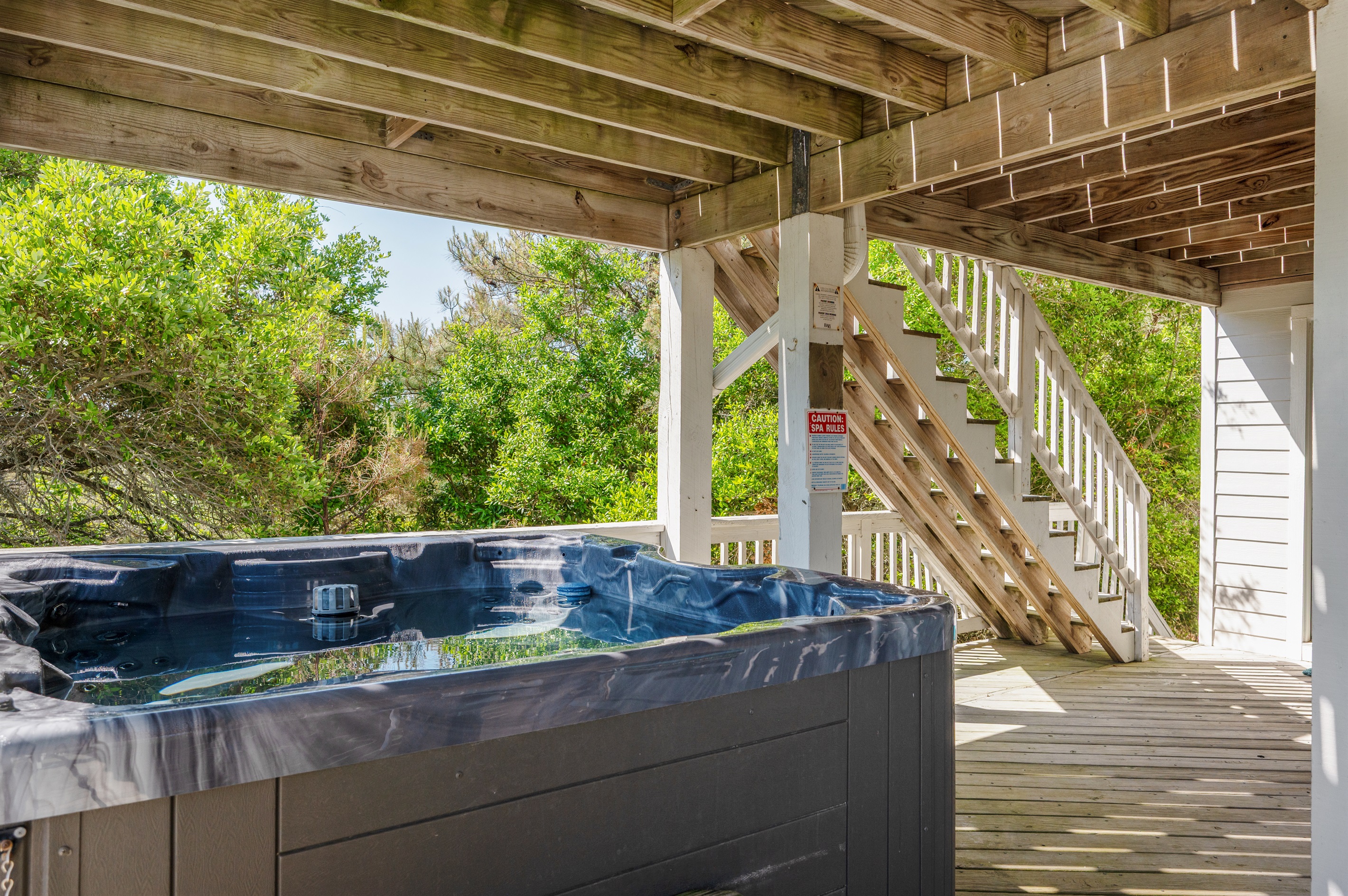 Unwind after beach days with a relaxing soak in the private hot tub.