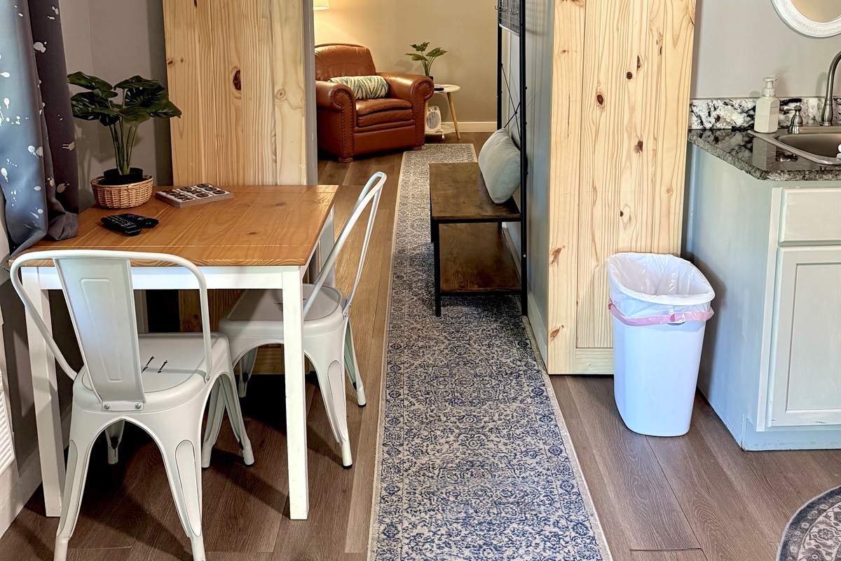 Barn doors to close off second bedroom for privacy. Small seating area in the room. 