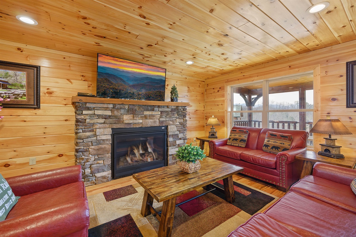 Main level living room with fireplace and TV