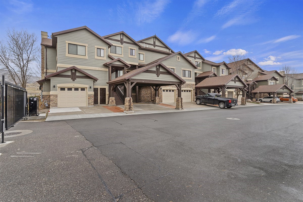 A beautifully maintained community exterior with ample guest parking, offering both convenience and a polished first impression in a quiet alpine setting.
