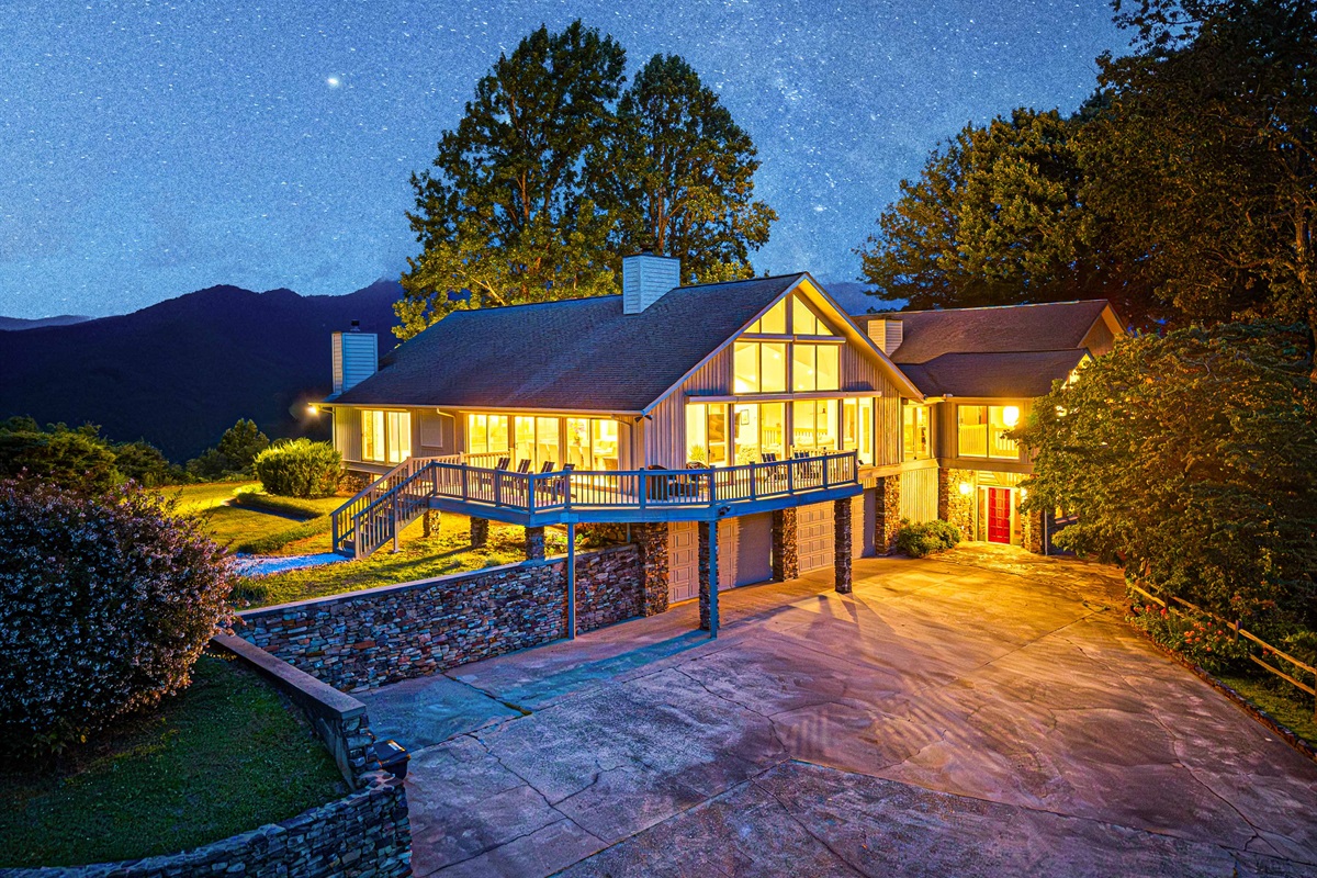 Exterior: Stunning mountain retreat with breathtaking views and inviting, warm lighting!